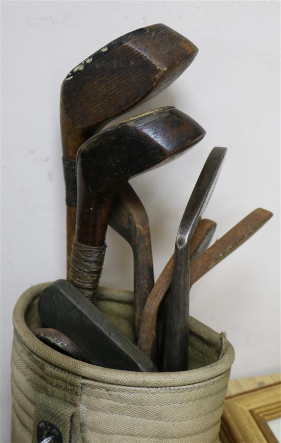Two wooden drivers by Armstrong & Co and Paxton, a gun metal putto signed Jacques, 7 other and a golf ball